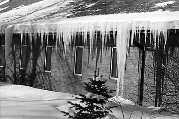 Photograph 2. The unusually high heat loss on this roof has caused both an ice dam and icicles.